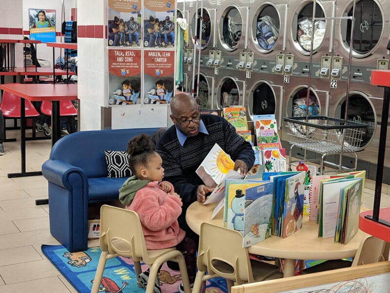 librarian reading to child in laundromat 800X600px